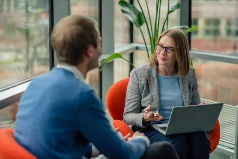 A man and a lady are talking about business